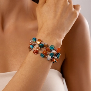 Detail of bohemian multi-layer handmade bracelet with colorful natural stones and shell beads