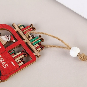 Red wooden Christmas ornament with white bead and twine string on a neutral background