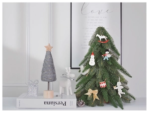 Detail of Nordic mini Christmas tree with wooden base and felt star tabletop ornaments