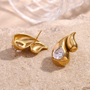 Macro shot of 18K gold teardrop earrings with sparkling pear-cut cubic zirconia