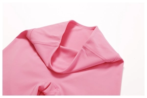 Close-up of pink high-waist yoga shorts showing professional flatlock stitching and fabric