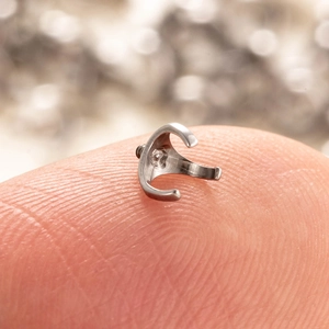 Titanium alloy F136 internally threaded ball mount stud piercing held on a fingertip