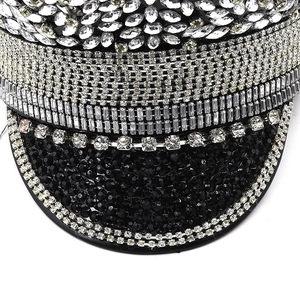 Macro detail of high-density silver rhinestones and black sequins on luxury flat top hat