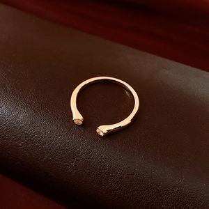 Detail view of adjustable rose gold rings with two round sparkling zircon stones
