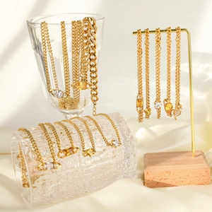 Golden Saturn planet necklace and bracelet set with sparkling crystals on display