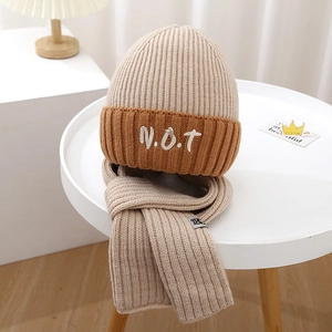 Detail of color-block knit hat and scarf set with N.O.T embroidery for boys