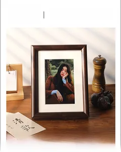 Detail of dark walnut solid wood photo frame showing natural texture in cozy room