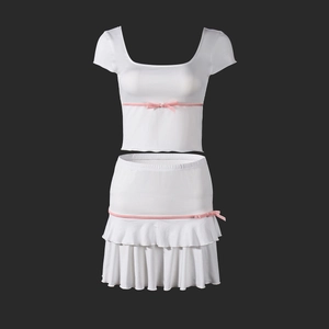 Detailed view of white short-sleeve top and tiered ruffle skirt with pink velvet bows