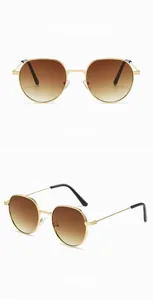 Close-up of retro round gold metal sunglasses with brown gradient lenses and C4 mark