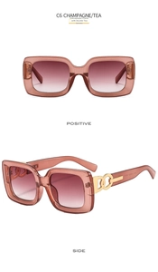 Detail of champagne square sunglasses featuring gold chain decoration and tea gradient lenses