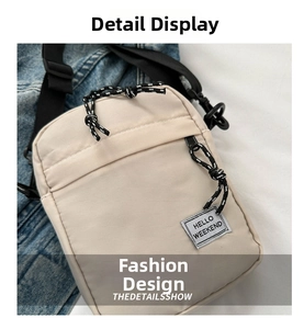 Detail of cream nylon crossbody bag with HELLO WEEKEND patch and woven zipper puller