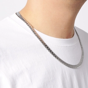 Close-up of silver stainless steel flat snake chain necklace worn on male neck