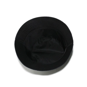 Detail view of the durable black cotton bucket hat showing interior stitching and lining