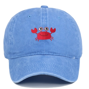 Detail of red crab embroidery on a washed blue cotton baseball cap with a curved brim