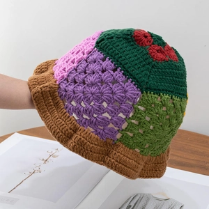 Close-up of handmade crochet bucket hat with colorful floral patterns and textures