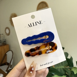 Blue and tortoiseshell wavy hair clips set on a display card for women and girls