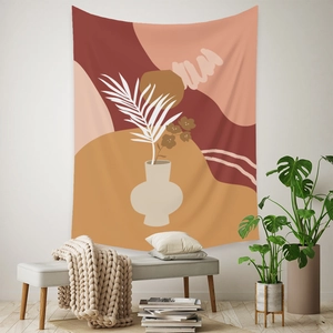 Detail of bohemian wall tapestry featuring abstract palm leaves and terracotta art blocks