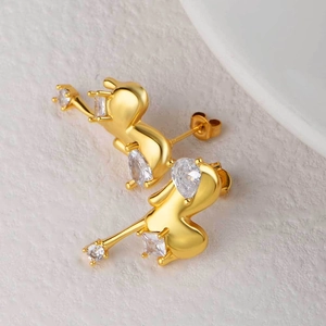 Elegant 18K gold plated heart earrings with sparkling cubic zirconia on beige texture