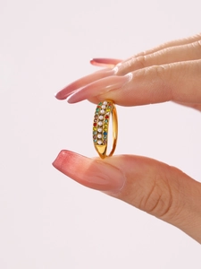 Detail of adjustable gold ring featuring multi-colored zircons and white pearls