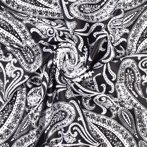 Detail of black and white paisley satin scarf with a luxurious silk-like spiral drape