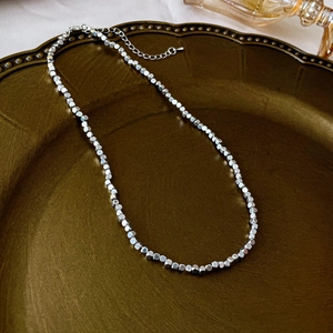 Detail of silver square bead necklace on vintage tray with adjustable lobster clasp