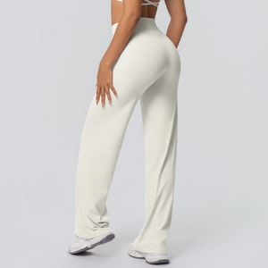 Close-up of high-waisted flared yoga pants in cream white with booty lifting seam detail