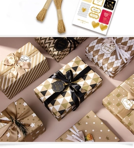 Detail of luxury gold foil gift wrap set with ribbons, twine, and elegant stickers