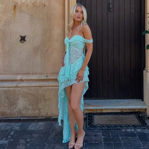 Detail of light blue lace dress featuring a bandeau neck and asymmetric high-low hemline