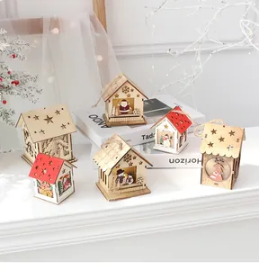Close-up of wooden Christmas house ornaments with warm LED lights and festive carvings