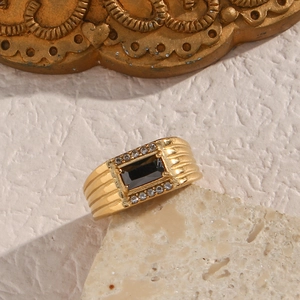 Macro shot of 18K gold plated ring featuring a black rectangular stone and white crystals