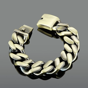 Detail of chunky Cuban chain bracelet in antique bronze finish with brushed metal texture