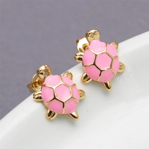 Macro view of pink enamel turtle earrings with golden edges and shell textures