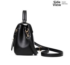 Side view of black matte leather handbag featuring gold hardware and a structured outline