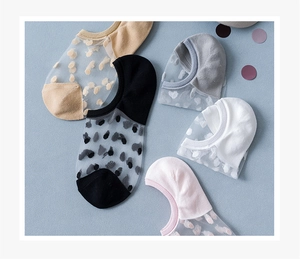 Flat lay of five sheer polka dot low cut socks in beige black grey white and pink