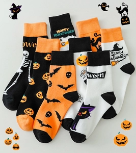 Flat lay showing various Halloween crew socks with pumpkin, ghost, and skull patterns