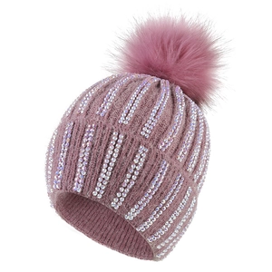 Women's knit beanie in plum purple with rhinestone embellishments and faux fur pompom