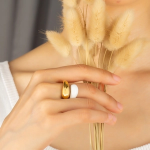 Minimalist gold and white enamel stainless steel ring showcased on model finger