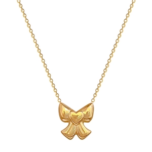 Golden titanium steel bow and heart pendant necklace displayed on a white background