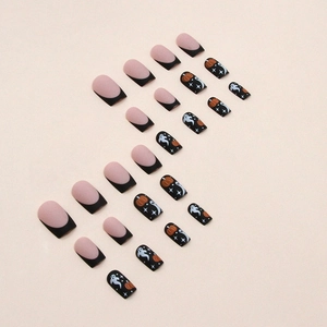 Matte Halloween press-on nails featuring pumpkin ghost patterns and black French tips