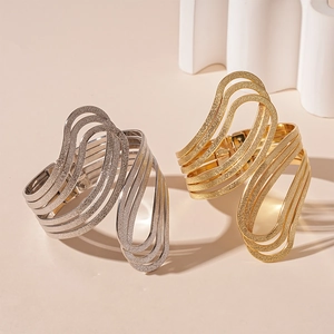 Irregular multilayer geometric open bracelet with matte metallic texture in gold and silver