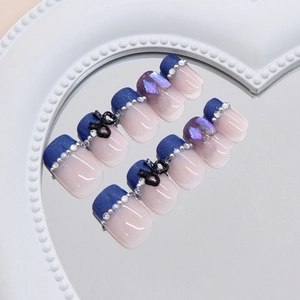 French glacial blue press-on nails with 3D bows, pearls and glitter on a heart tray