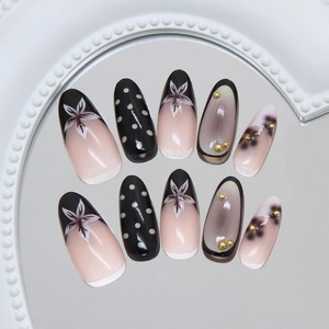 French retro almond press-on nails with black floral patterns and gold beads