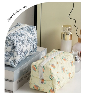 Detailed view of quilted floral cosmetic bags showing soft fabric texture and zippers