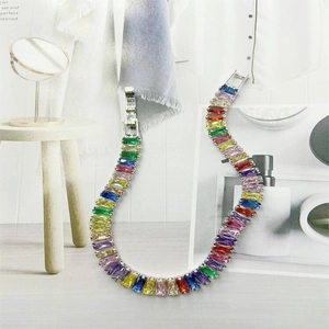 Rainbow rectangular zirconia bracelet in silver setting on a stylish fashion magazine background