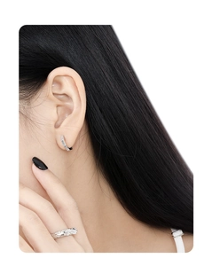 Close-up of minimalist S925 sterling silver hoop earrings with irregular vertical texture