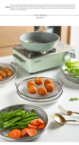Close-up of stainless steel round cooling rack with mesh design and side handles for frying