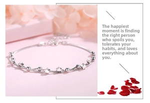 Close-up of S925 sterling silver double-layer star bracelet with pink rose petals
