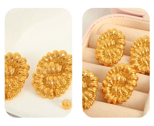 Detailed macro view of vintage twisted gold titanium steel earrings in a pink velvet box