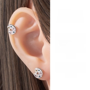 Close-up of silver cartilage piercing stud with colorful zircon and enamel details