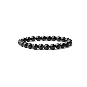 Detail of a natural black agate beaded bracelet with polished round stones on white background